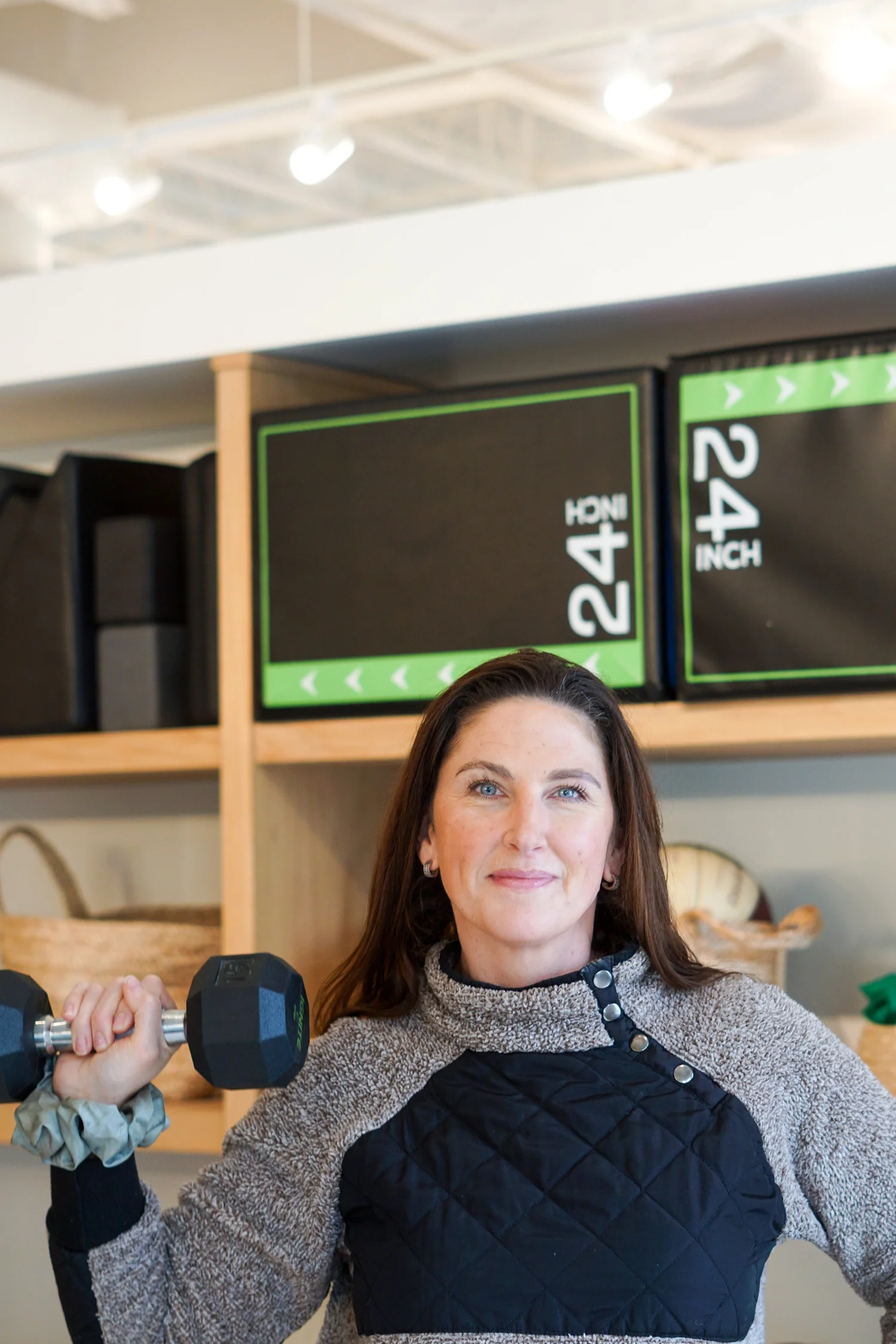 Personal trainer supporting a client with strength training.