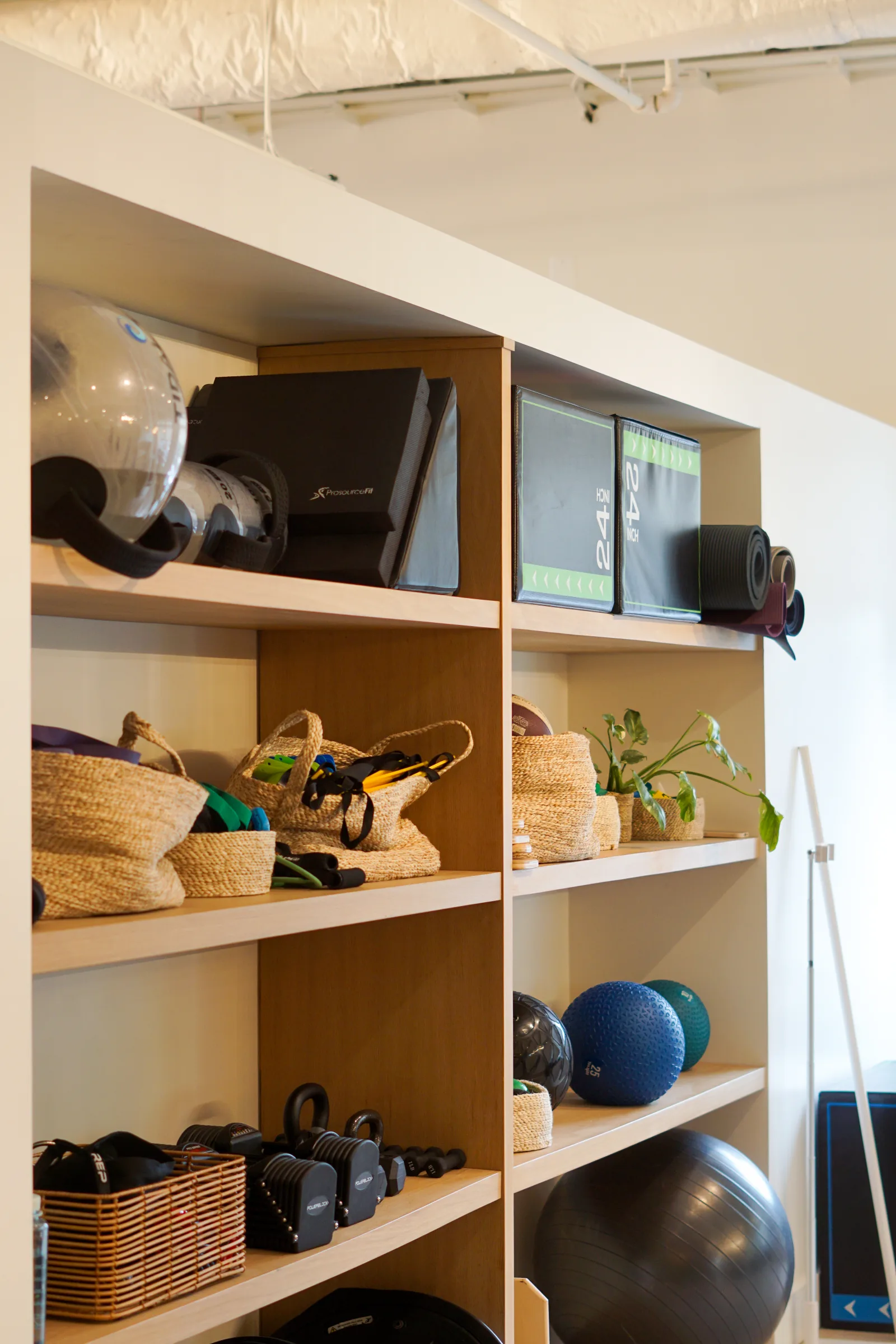 Organized wellness equipment shelves at Great Falls Movement Center.